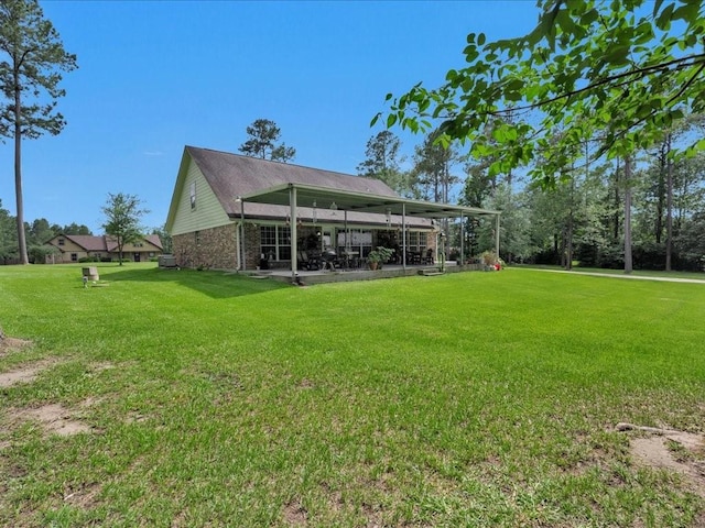 238 Royal Pnes, Lufkin, TX 75904 - back of house with a lawn, a patio, and brick siding