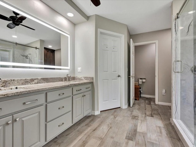 238 Royal Pnes, Lufkin, TX 75904 - full bath featuring ceiling fan, a marble finish shower, double vanity, and wood finished floors