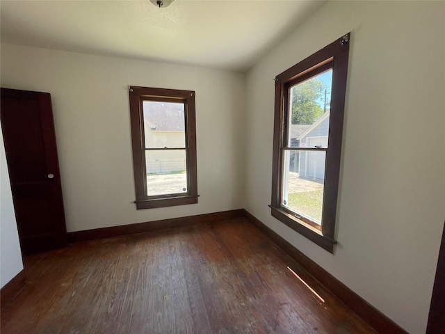 611 Fahrenthold St, El Campo, TX 77437 - unfurnished room with dark wood-type flooring and baseboards
