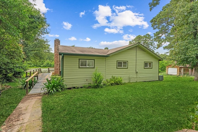 11104 Quinlan N Lake Dr, Conroe, TX 77303 - rear view of house with a lawn, a chimney, and a deck