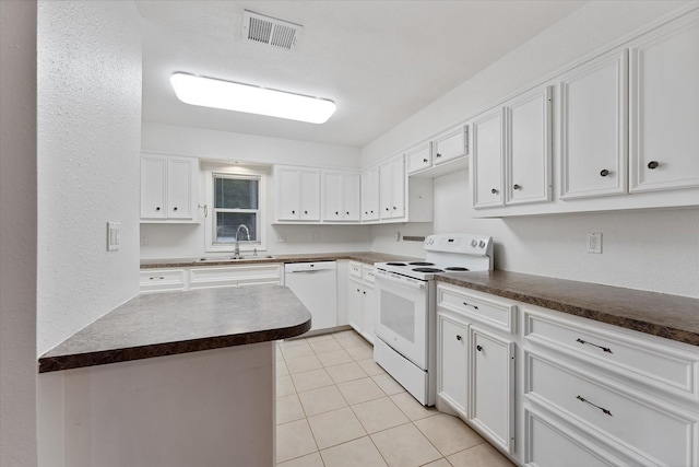 11104 Quinlan N Lake Dr, Conroe, TX 77303 - kitchen featuring white appliances, dark countertops, white cabinetry, and light tile patterned floors