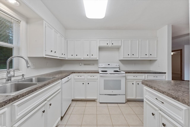 11104 Quinlan N Lake Dr, Conroe, TX 77303 - kitchen with white appliances, white cabinetry, light tile patterned flooring, and dark countertops