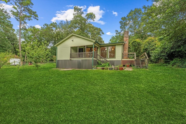11104 Quinlan N Lake Dr, Conroe, TX 77303 - rear view of property with a lawn, stairway, a chimney, and a deck
