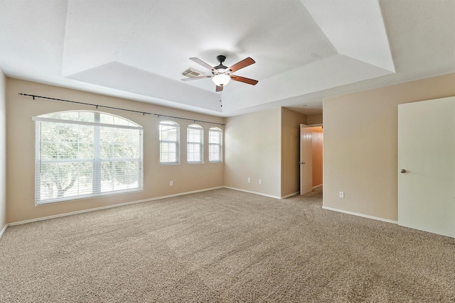 526 Trail Springs Ct, Kingwood, TX 77339 - empty room featuring a raised ceiling, ceiling fan, carpet floors, and baseboards