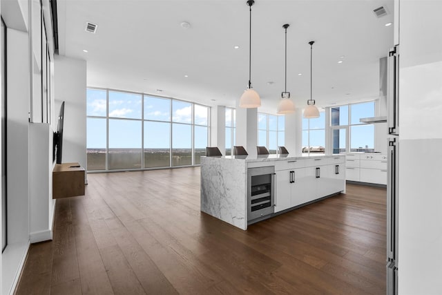 4521 San Felipe St Unit 3101, Houston, TX 77027 - kitchen with modern cabinets, beverage cooler, white cabinetry, a large island with sink, and open floor plan