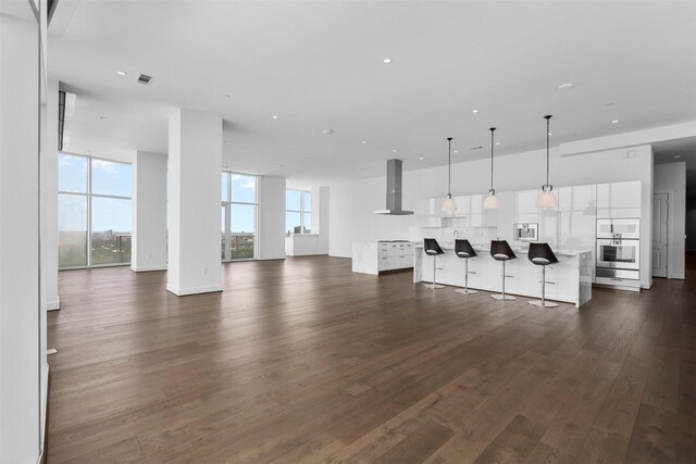 4521 San Felipe St Unit 3101, Houston, TX 77027 - unfurnished living room featuring dark wood-style floors and recessed lighting
