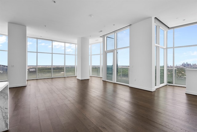 4521 San Felipe St Unit 3101, Houston, TX 77027 - unfurnished living room with expansive windows, healthy amount of natural light, and dark wood-style floors