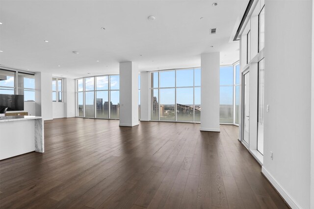 4521 San Felipe St Unit 3101, Houston, TX 77027 - unfurnished living room featuring dark wood-type flooring and a wall of windows