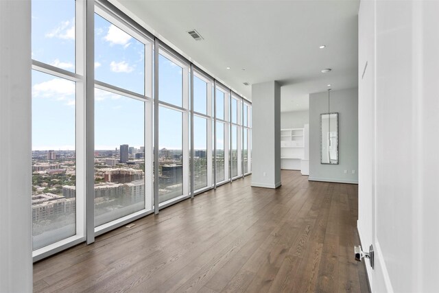 4521 San Felipe St Unit 3101, Houston, TX 77027 - spare room featuring dark wood finished floors, floor to ceiling windows, and a water view