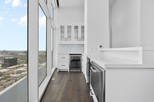 4521 San Felipe St Unit 3101, Houston, TX 77027 - indoor dry bar featuring wine cooler, dark wood-type flooring, and stainless steel dishwasher
