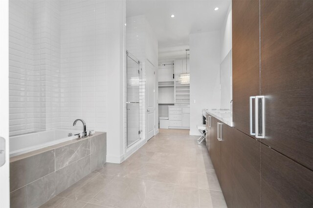 4521 San Felipe St Unit 3101, Houston, TX 77027 - full bathroom featuring vanity, a garden tub, a shower stall, tile patterned floors, and recessed lighting