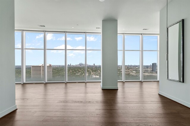 4521 San Felipe St Unit 3101, Houston, TX 77027 - spare room featuring hardwood / wood-style floors, plenty of natural light, a wall of windows, and a city view