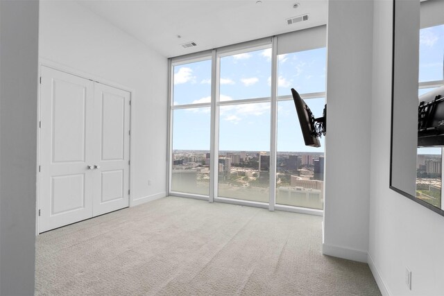 4521 San Felipe St Unit 3101, Houston, TX 77027 - unfurnished bedroom featuring carpet flooring, multiple windows, and a wall of windows