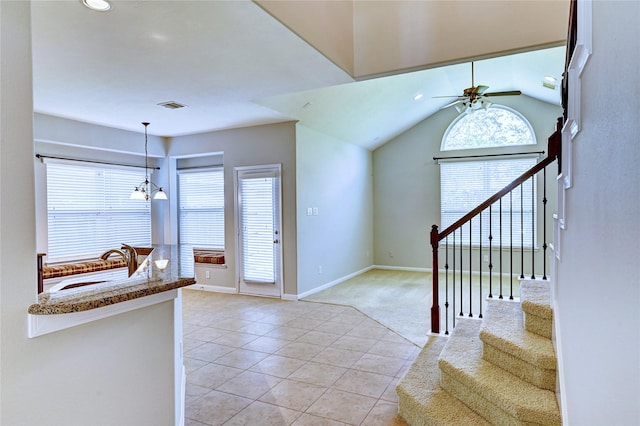 24430 Silverton Valley Ln, Katy, TX 77494 - entrance foyer with light tile patterned floors, ceiling fan, baseboards, a chandelier, and light colored carpet