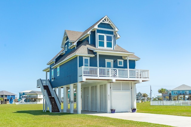4003 Kiva Rd, Galveston, TX 77554 - raised beach house with roof with shingles, concrete driveway, a garage, and a front lawn