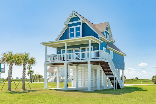 4003 Kiva Rd, Galveston, TX 77554 - view of front of property featuring board and batten siding, a front yard, roof with shingles, and stairs