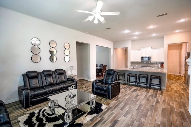 31007 Laurel Creek Ln, Conroe, TX 77385 - living area featuring wood finished floors, a ceiling fan, baseboards, and recessed lighting