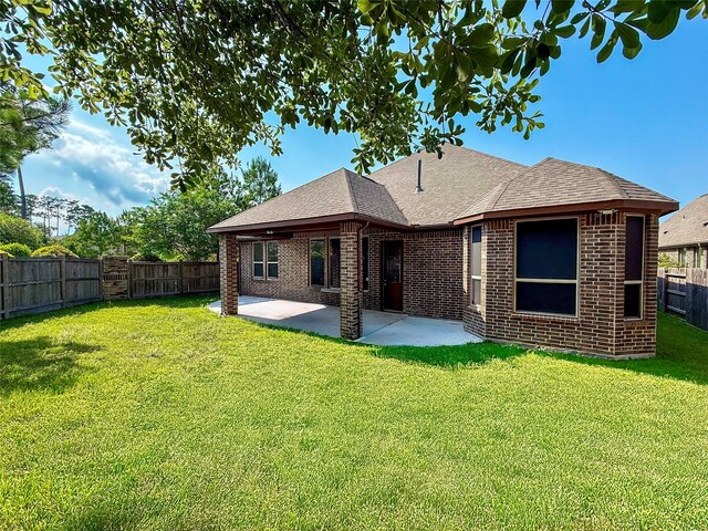 31007 Laurel Creek Ln, Conroe, TX 77385 - back of property featuring brick siding, a patio, and roof with shingles