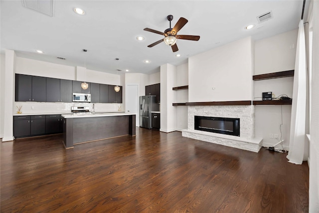 2508 Hadley St, Houston, TX 77003 - kitchen featuring stainless steel appliances, open floor plan, light countertops, ceiling fan, and decorative backsplash
