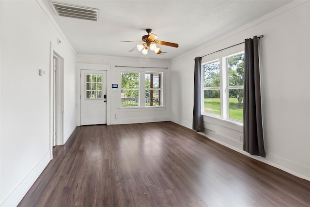 12602 24th St, Santa Fe, TX 77510 - spare room featuring dark wood-style flooring, baseboards, ceiling fan, and crown molding