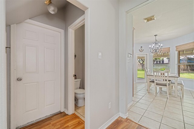 5325 High Bank Dr, Corpus Christi, TX 78413 - hall featuring a chandelier, baseboards, and light tile patterned flooring