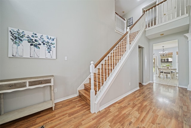 5325 High Bank Dr, Corpus Christi, TX 78413 - staircase with wood finished floors, a chandelier, baseboards, and a towering ceiling