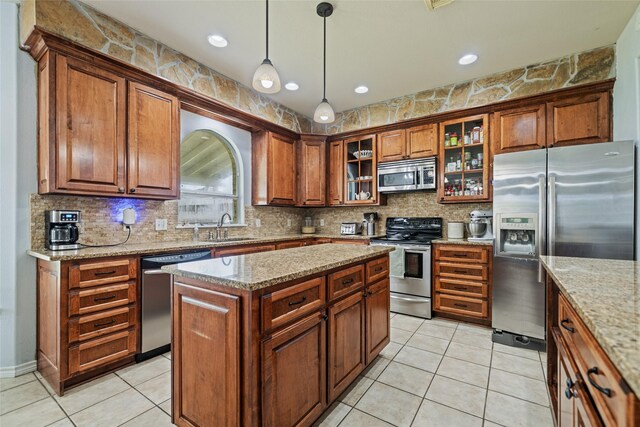 5325 High Bank Dr, Corpus Christi, TX 78413 - kitchen with appliances with stainless steel finishes, a sink, tasteful backsplash, and decorative light fixtures