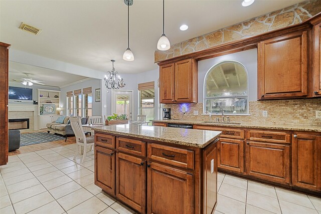 5325 High Bank Dr, Corpus Christi, TX 78413 - kitchen featuring a sink, light tile patterned floors, a fireplace, a ceiling fan, and decorative backsplash