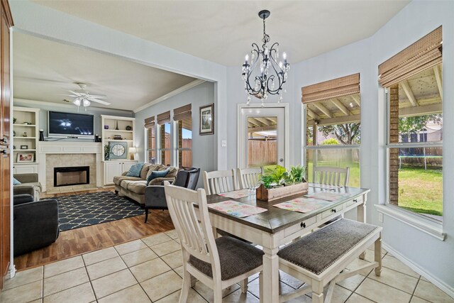 5325 High Bank Dr, Corpus Christi, TX 78413 - dining space featuring light tile patterned floors, a tile fireplace, baseboards, and a chandelier