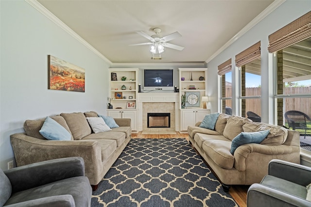 5325 High Bank Dr, Corpus Christi, TX 78413 - living area featuring crown molding, wood finished floors, a ceiling fan, a fireplace, and built in features