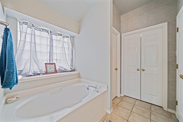 5325 High Bank Dr, Corpus Christi, TX 78413 - bathroom with a bath, baseboards, tile patterned flooring, and a closet