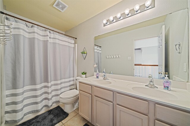 5325 High Bank Dr, Corpus Christi, TX 78413 - full bath featuring double vanity, tile patterned floors, toilet, and curtained shower