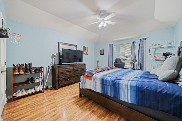 5325 High Bank Dr, Corpus Christi, TX 78413 - bedroom featuring light wood-style flooring, a ceiling fan, and a raised ceiling