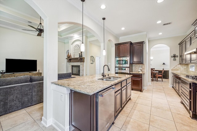 110 Deer Plain Dr, Spring, TX 77389 - kitchen featuring a sink, appliances with stainless steel finishes, ornamental molding, ceiling fan, and open floor plan