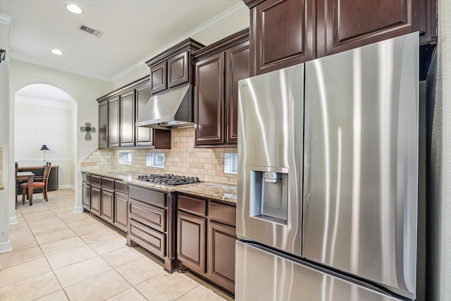 110 Deer Plain Dr, Spring, TX 77389 - kitchen with appliances with stainless steel finishes, arched walkways, light tile patterned floors, ornamental molding, and range hood