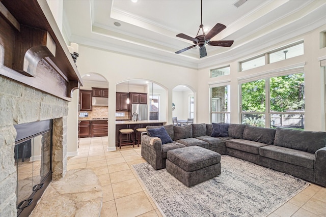 110 Deer Plain Dr, Spring, TX 77389 - living area featuring crown molding, ceiling fan, light tile patterned floors, a high ceiling, and a fireplace