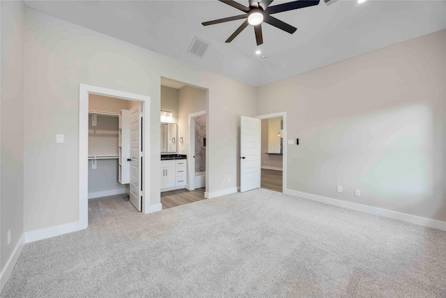 3711 Bain St, Houston, TX 77026 - unfurnished bedroom featuring light carpet, a spacious closet, baseboards, a closet, and recessed lighting