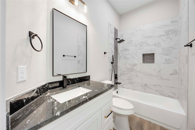 3711 Bain St, Houston, TX 77026 - bathroom with vanity, toilet, shower / bath combination, and wood finished floors