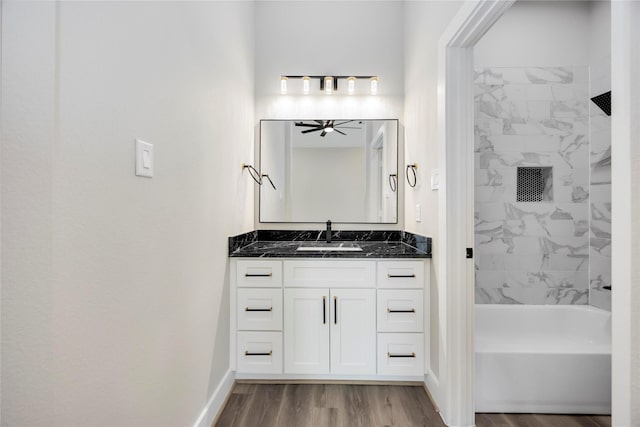 3711 Bain St, Houston, TX 77026 - full bathroom with wood finished floors, vanity, ceiling fan, baseboards, and shower / bathtub combination