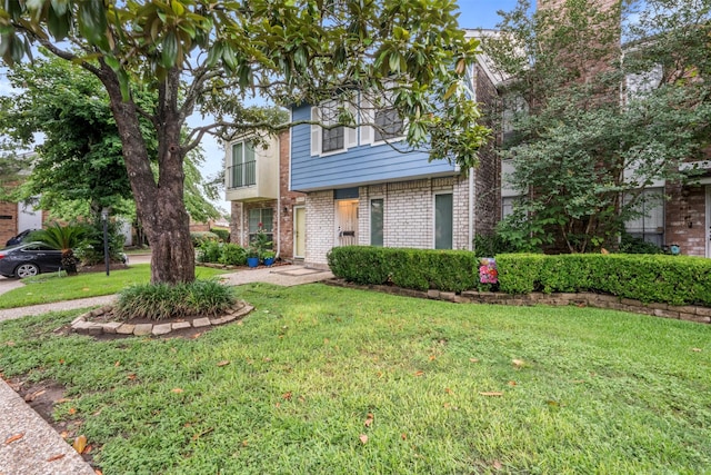 9501 Fondren Rd Unit 9, Houston, TX 77074 - view of front facade with brick siding and a front yard