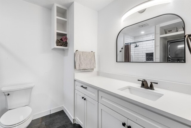9501 Fondren Rd Unit 9, Houston, TX 77074 - bathroom with vanity, toilet, tiled shower, and baseboards