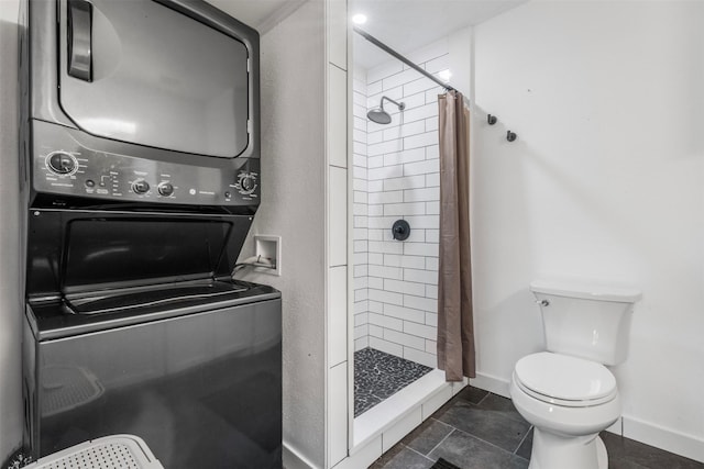 9501 Fondren Rd Unit 9, Houston, TX 77074 - full bathroom with stacked washer / dryer, a stall shower, toilet, and baseboards