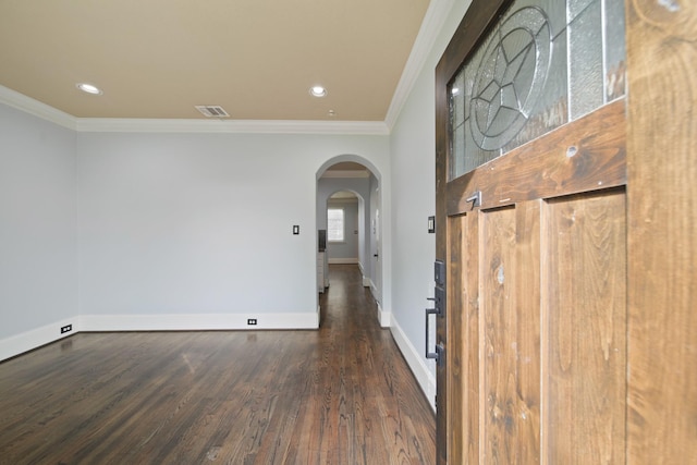 1773 Aden Dr, Houston, TX 77003 - foyer entrance featuring ornamental molding, arched walkways, wood finished floors, baseboards, and recessed lighting