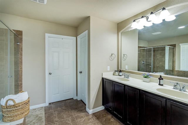 2039 Wembley Way, Rosenberg, TX 77471 - bathroom featuring a stall shower, double vanity, and baseboards