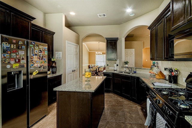 2039 Wembley Way, Rosenberg, TX 77471 - kitchen featuring black appliances, arched walkways, decorative backsplash, a sink, and recessed lighting