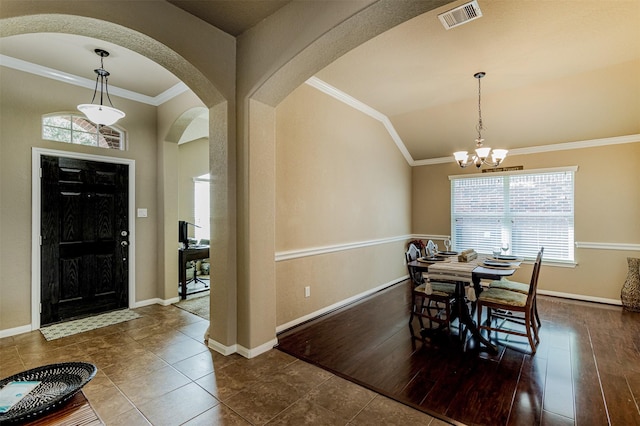 2039 Wembley Way, Rosenberg, TX 77471 - tiled dining room with arched walkways, plenty of natural light, crown molding, a chandelier, and baseboards