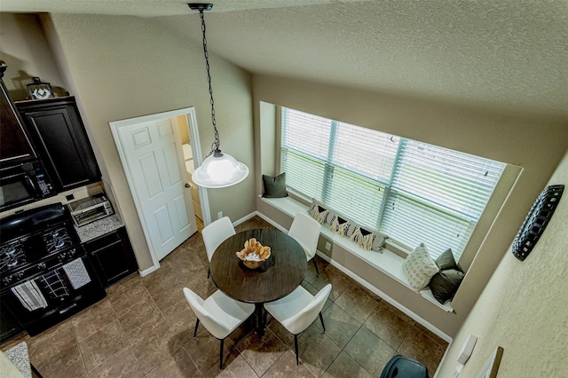 2039 Wembley Way, Rosenberg, TX 77471 - living room featuring a textured ceiling, dark tile patterned floors, and baseboards