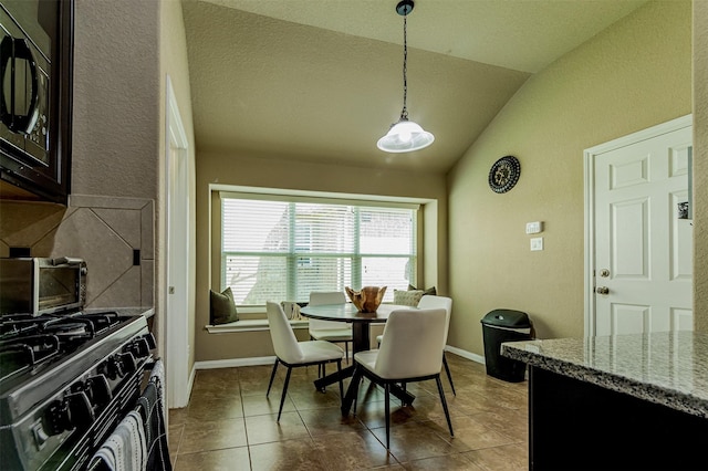 2039 Wembley Way, Rosenberg, TX 77471 - dining space with lofted ceiling, a textured wall, tile patterned floors, and baseboards