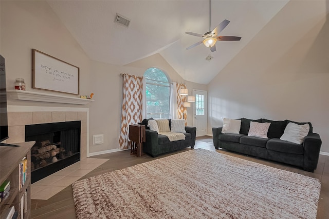21415 Park Timbers Ln, Katy, TX 77450 - living room featuring a ceiling fan, wood finished floors, a fireplace, high vaulted ceiling, and baseboards