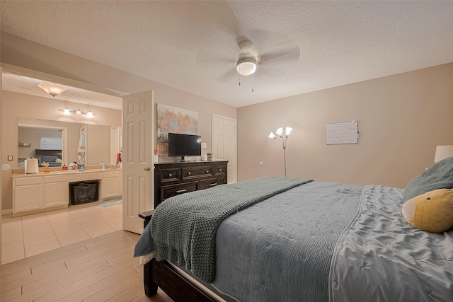 21415 Park Timbers Ln, Katy, TX 77450 - bedroom with light wood-style flooring, a textured ceiling, ensuite bathroom, and ceiling fan
